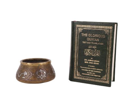 An Islamic Cairo ware Damascus silver inlaid brass bowl in the Ottoman style, 2cms diameter; together with a copy of the Glor