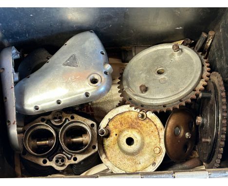 Assorted Triumph Twin motorcycle spares including cylinders, rocker cover and gearbox cover, brake hubs and other components.
