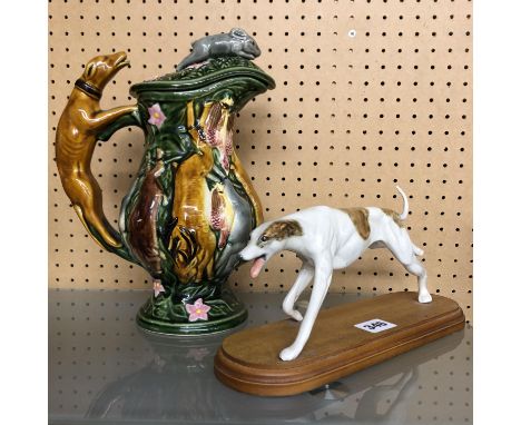 HUNTING SCENE CERAMIC PITCHER JUG WITH DOG HANDLE A/F 28CM H AND A CERAMIC GREYHOUND FIGURE MOUNTED ON A WOODEN PLINTH