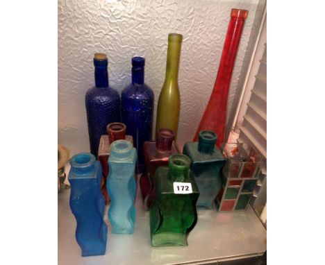 SELECTION OF RUBY, TANGERINE, AMETHYST AND BRISTOL BLUE WAVY GLASS BOTTLES AND OTHERS