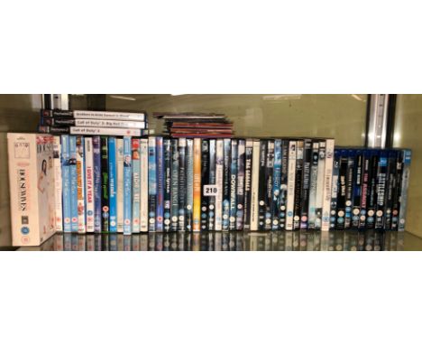SHELF OF VARIOUS DVDS AND SOME PLAYSTATION 2 GAMES