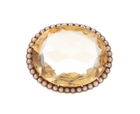 YELLOW GEM SET PENDANT,set with a large faceted yellow gem within a seed pearl border, 36mm high, to an unmarked mount, 17.2g