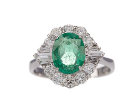 EMERALD AND DIAMOND RING,set with an oval emerald of approximately 1.48 carats, flanked by baguette and round brilliant cut d