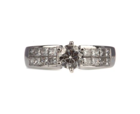 DIAMOND DRESS RING,the high set round brilliant cut diamond of approximately 0.54 carats flanked by two rows of princess cut 