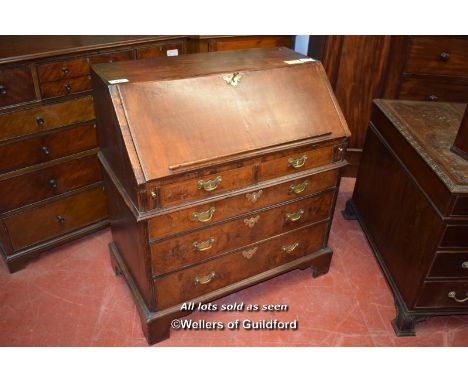 LATE 18TH CENTURY WALNUT BUREAU, THE FALL FLAP ENCLOSING PIGEONHOLES OVER TWO SHORT AND THREE LONG GRADUATED DRAWERS ON BRACK