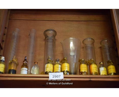 SHELF OF CHEMIST JARS AND TEST TUBES