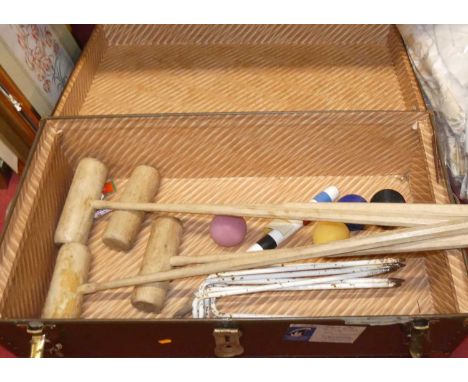 A metal bound trunk containing croquet set including four mallets