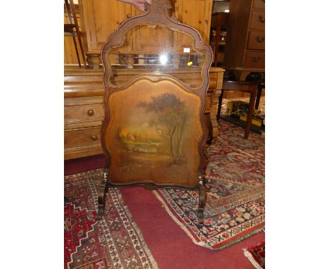 A mid-19th century continental floral carved walnut firescreen, having a glazed inset upper panel over a colour print lower i