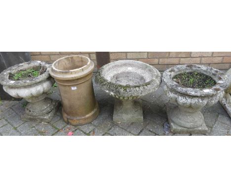 A pair of reconstituted stone squat pedestal garden planters; together with a single garden planter and a terracotta cylindri