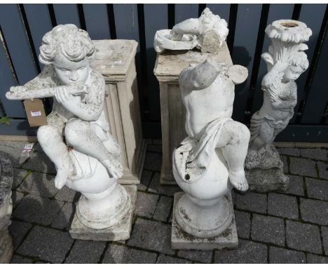 A pair of white painted reconstituted stone garden statues, one modelled as Pan seated on a finial and the other as a tambour