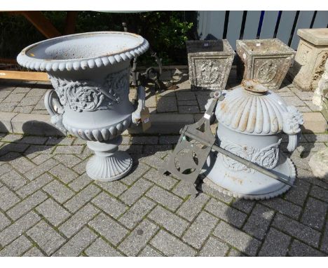 A grey painted cast iron twin handled pedestal garden urn, in the classical taste with gadrooned detail and floral garland de