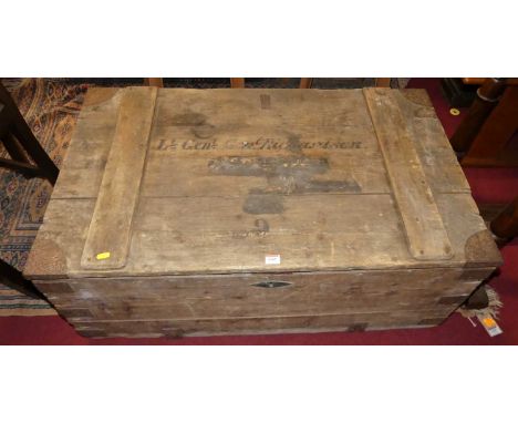 An early 20th century planked pine and metal bound hinge topped travelling trunk, having iron end carry handles, w.104cm 