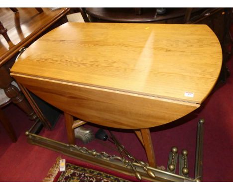 A contemporary Ercol pine dropflap kitchen table, length 113cm 