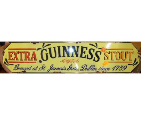 An enamel on metal wall mounted advertising sign for Guinness Extra Stout, 12.5x56.5cm
