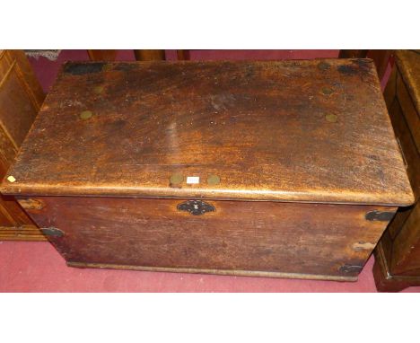 A 19th century colonial mahogany and brass mounted hinge topped travelling trunk, having iron end carry handles, raised on sq