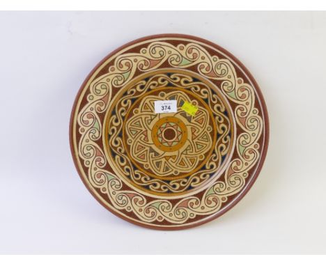 Celtic design studio pottery platter, marked to back MS98, measuring 34 cm diameter