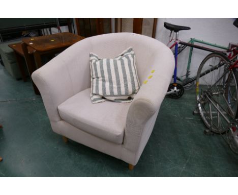 Cream coloured armchair with striped cushion 