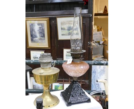 Oil lamp with pale pink glass reservoir and a brass Aladdin lamp base 