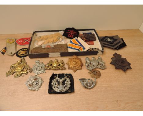 A tray of Cloth Badges and Epaulettes along with metal badges including Liverpool Scottish, Scottish Kings Borderers, Flintsh
