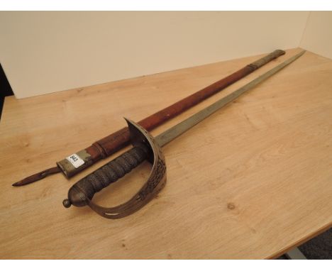 A British Infantry Officer's Sword 1895 Pattern with brown leather scabbard, decorated blade, proof button, Makers Mark Langd