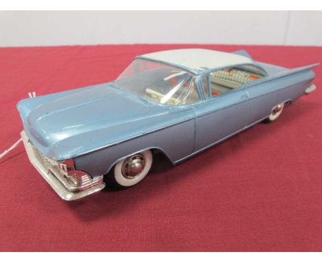 A 1960s Gama Plastic/Tinplate Model of a Cadillac, white/blue Push 'N' Go, some wear 22cm long.