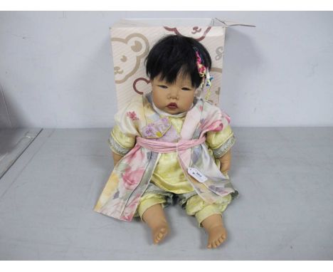 A Carlos Gotz Dribble Doll 162/24, in decorative clothing approximately 54cm high, with a non associated Steiff box