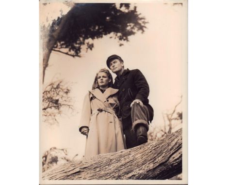 Black and white photo of a scene from film "Edge of Darkness", featuring Ann Sheridan and Errol Flynn.'Ann Sheridan, Errol Fl