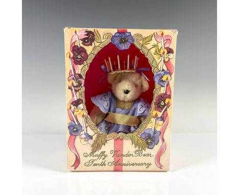 Adorable plush teddy bear in a blue dress and yellow sash. This item has its original box, 10"L x 7.75"W x 3.5"H. Issued: 20t