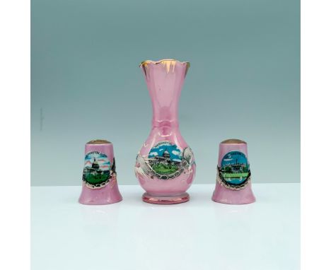 A set of 3 pink kitchen items that are decorated with copper-colored accents with the main design being a central art piece o