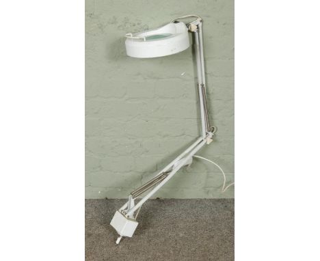 A Daylight DS250 Fluorescent Magnifier Lamp, with angle poise design and mounting bracket.  Tested and is working.