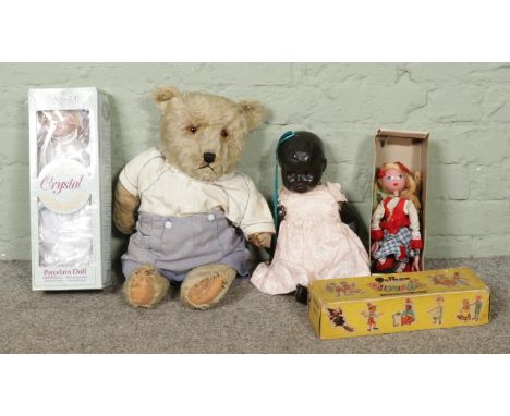A vintage toy collection, including ceramic and porcelain dolls, dressed teddy bear (seated H43cm) and a boxed wooden puppet.
