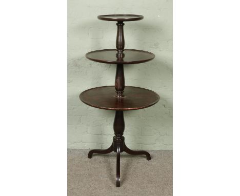 A George III mahogany three tier dumb waiter raised on tripod supports.Hx122cm approx