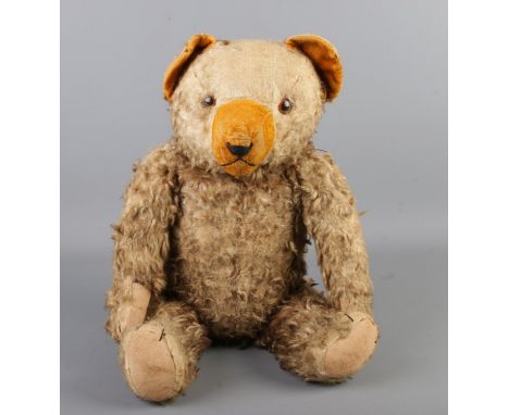 An early to mid 20th century jointed bear, possibly Hermann. Seated height 34cm.