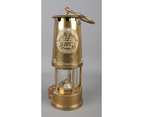 An Eccles Type 6 brass miner's safety lamp by the Protector Lamp and Lighting Co. Ltd. stamped number 1587.