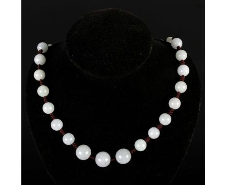 A vintage jade bead necklace, length 58cm with adjustable cord, largest bead D1.5cm.