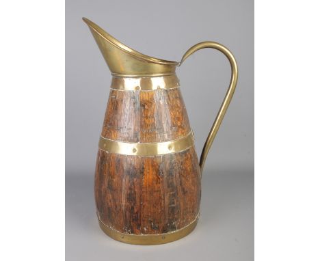 A large brass bound coopered barrel pitcher. Approx. height 48cm.  Label to underside heavily damaged.