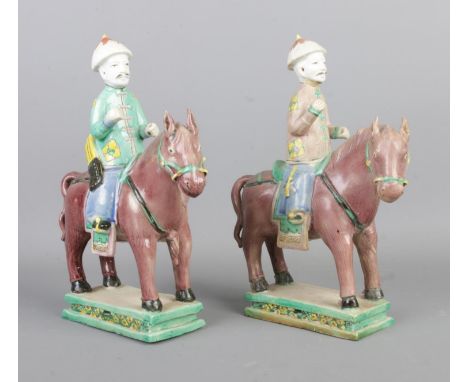 A pair of Tang style Sancai glazed men on horseback, one as an archer. Height: 22cm.  Slight chip to the pommel of the helmet