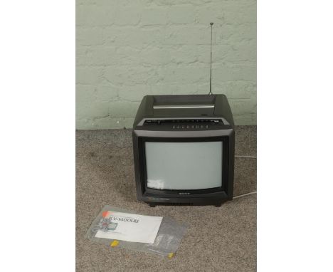 A Sony Trinitron KV-1400UB colour TV receiver in original box with instruction manual.