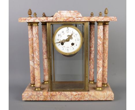An antique French marble pillared mantel clock by Bennet &amp; Pottier, featuring an enamel dial with Arabic numerals. Size: 