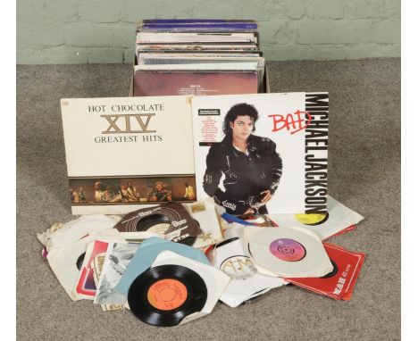 A box of LP and single records. Includes Michael Jackson, Stevie Wonder, The Beach Boys, HawkWind, Status Quo, Blaster Bates 