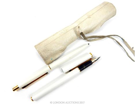 A vintage set of two Mont Blanc pens with yellow metal components to include a ball-point pen and a fountain pen. Both pens m