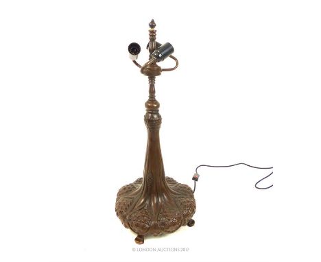 A very large, Tiffany style lamp base in bronzed metal, the bulbous, circular base featuring eight, stylised pine cones risin