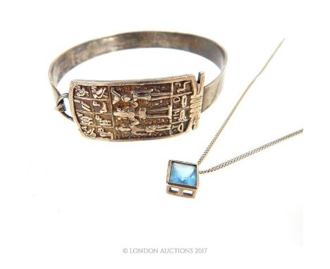 A silver bangle and a necklace.