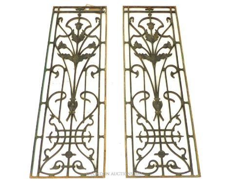 A matching pair of long, cast iron, Art Nouveau, grilles/panels, each panel composed of a central, stylised thistle with whip