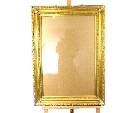 A large, rectangular, carved, gilt frame with glass panel. (Slight loss/damage to bottom left hand-corner carved decoration).