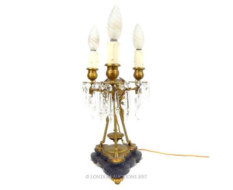 A 19th century, French, gilt metal, 3 branch table light with crystal drops in the neo-classical style with grotesques and Gr