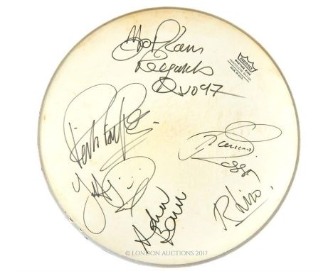A vintage 'Remo' drum head signed by Status Quo band members in thick black ink, dated 1997, Dia: 37 cm. 