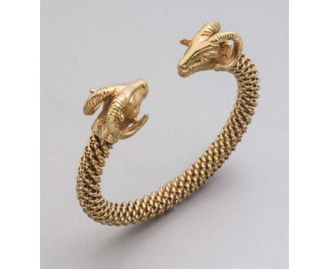 A FILIPPINI 18CT GOLD ARCHAEOLOGICAL REVIVAL TORQUE, the flexible woven chain with ram's head mask terminals, maker's applied