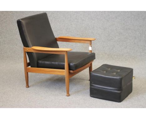 A 1960'S TEAK FRAMED ARMCHAIR with adjustable back and seat, with loose cushions in black faux leather, straight top rail, sh