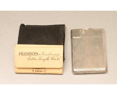 A SILVER CIGARETTE LIGHTER, maker Asprey &amp; Co. Ltd., London 1951, of plain oblong form with engine turning, 2 1/8" x 1 1/